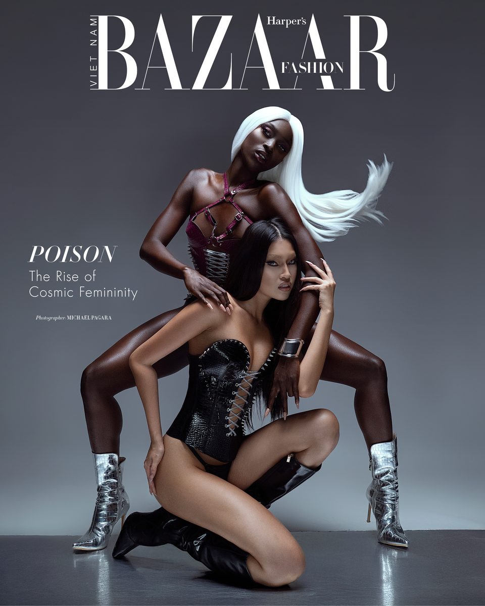 Harper's Bazaar cover: two models in corsetry and metallic boots against a grey backdrop.